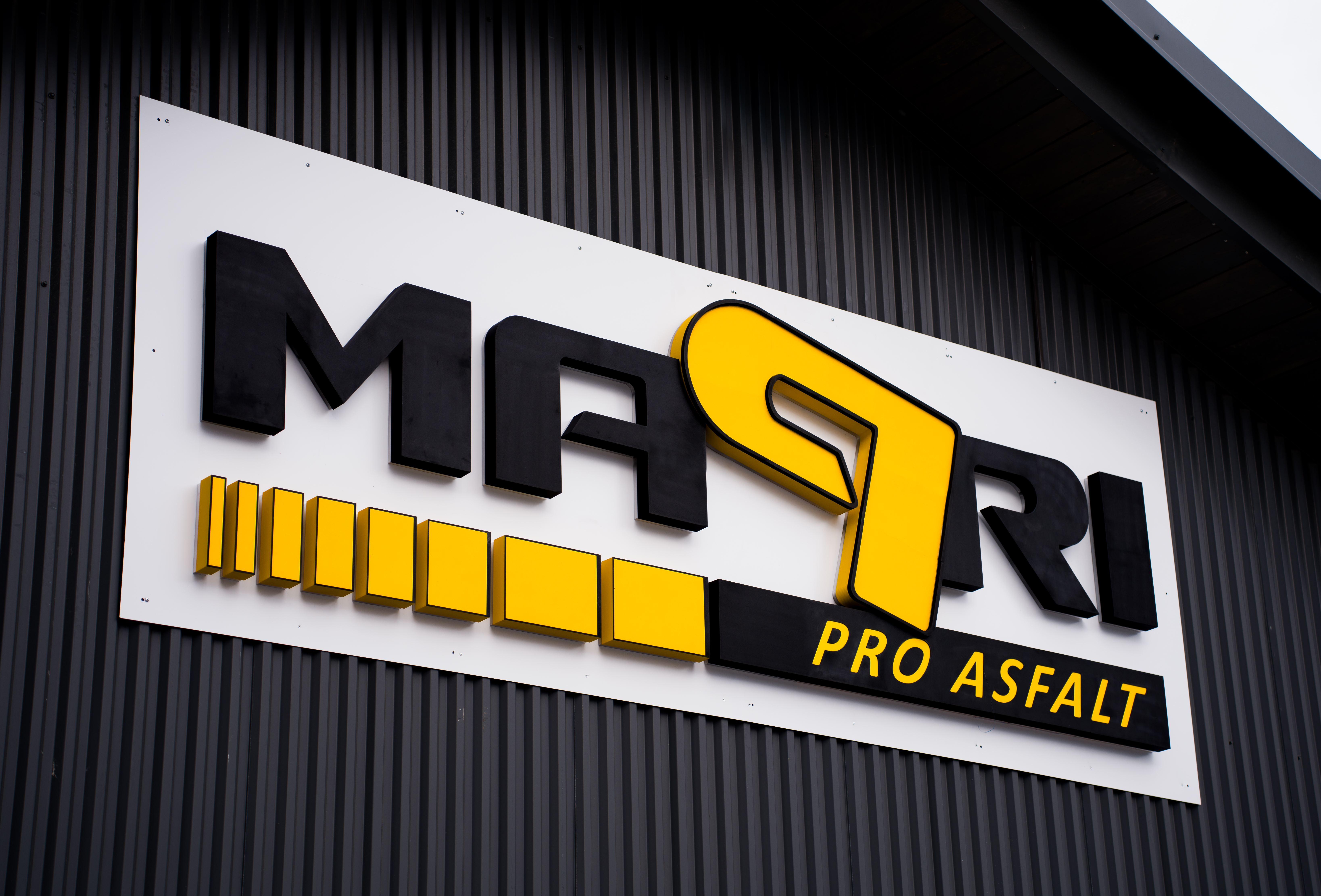 Non-illuminated branding sign in daylight