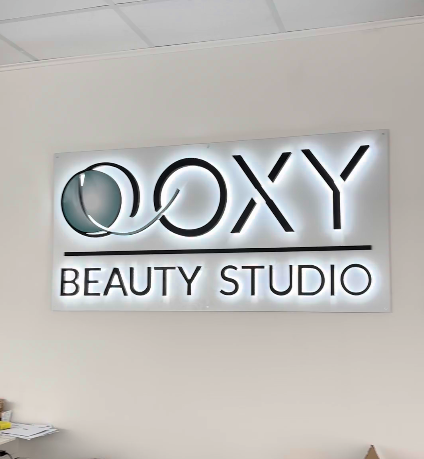 OOXY Beauty Studio back-lit sign